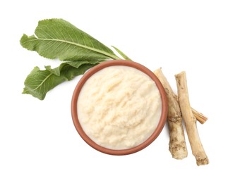 Photo of Tasty horseradish sauce in bowl, roots and leaves isolated on white, top view