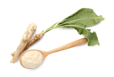 Photo of Tasty horseradish sauce in spoon, roots and leaves isolated on white, top view