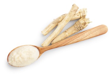 Photo of Tasty horseradish sauce in spoon and roots isolated on white, top view