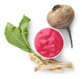 Photo of Tasty horseradish sauce in bowl, beetroot, leaves and roots isolated on white, top view