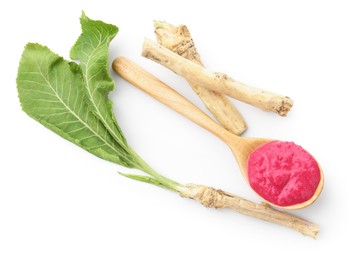 Photo of Tasty horseradish sauce with beetroot in spoon, roots and leaves isolated on white, top view
