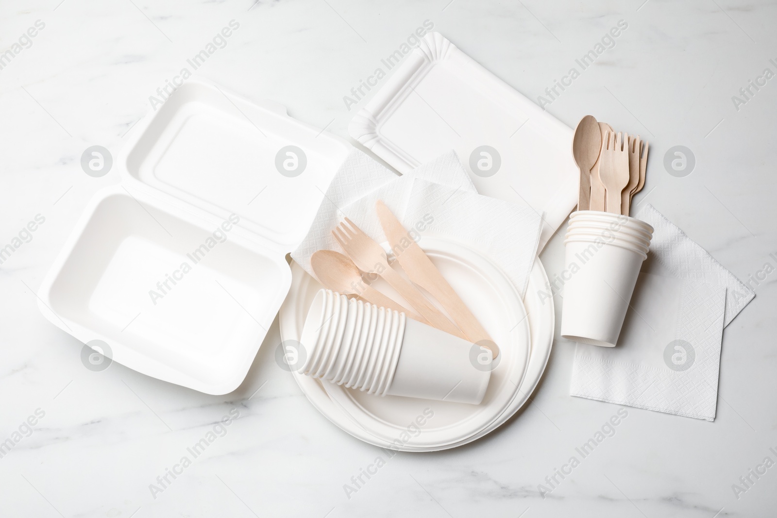 Photo of Set of disposable tableware on white background, flat lay