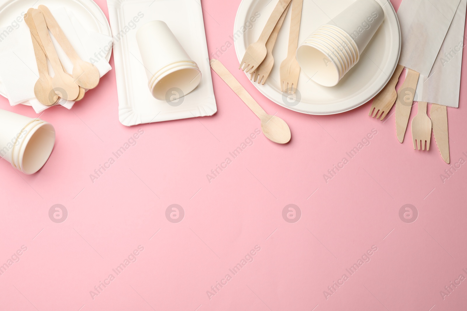 Set of disposable tableware on pink background, flat lay. Space for text Photo of Set of disposable tableware on pink background, flat lay. Space for text