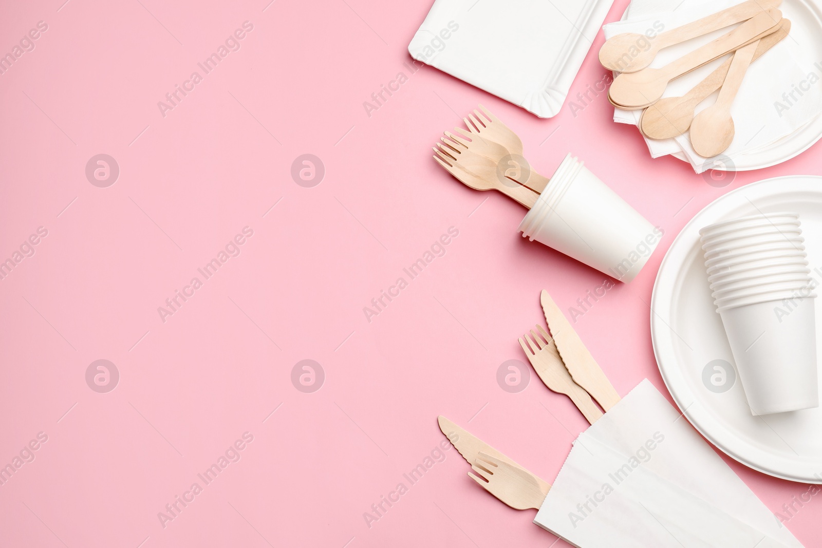 Set of disposable tableware on pink background, flat lay. Space for text Photo of Set of disposable tableware on pink background, flat lay. Space for text