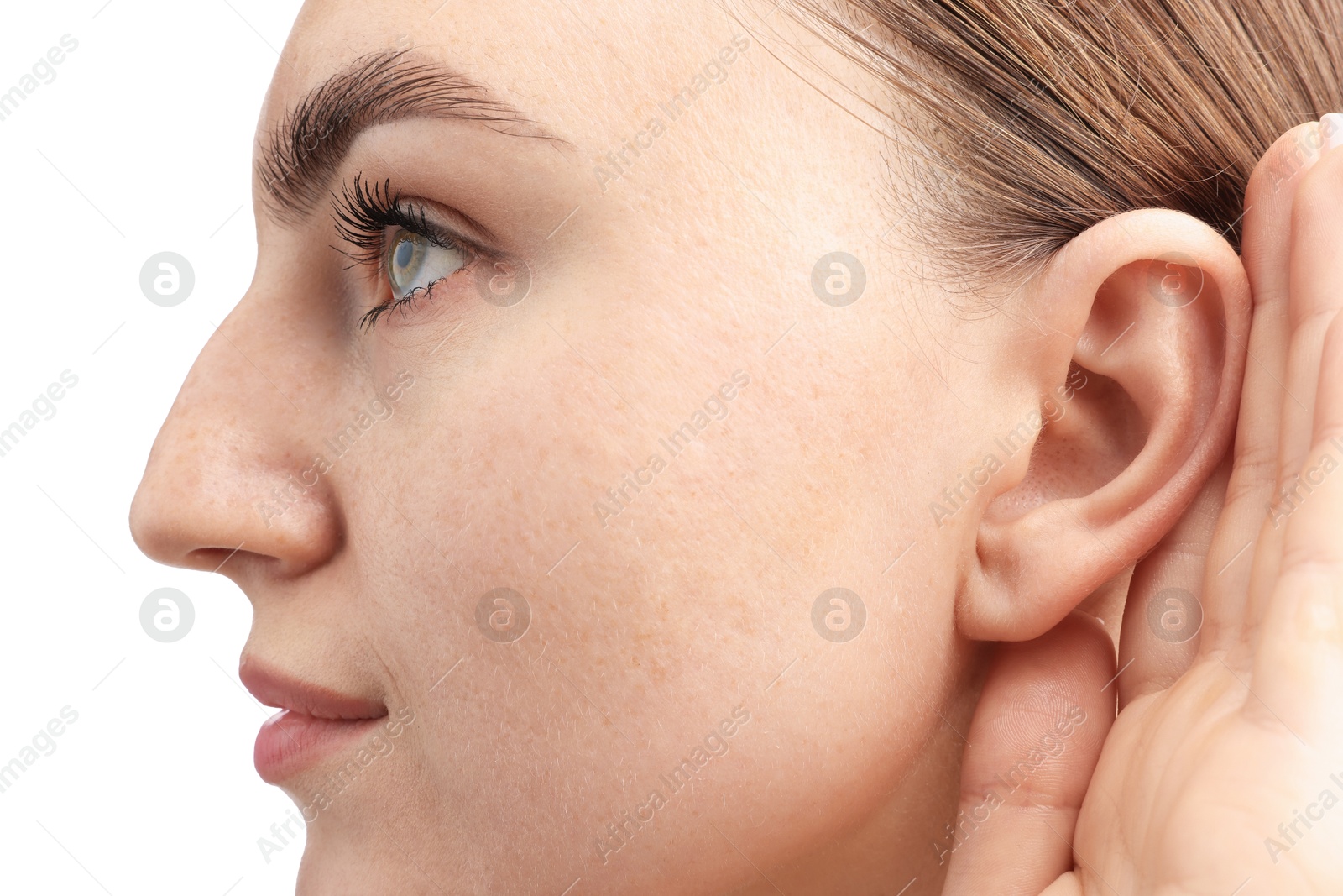Photo of Sound. Woman showing hand to ear gesture on white background, closeup