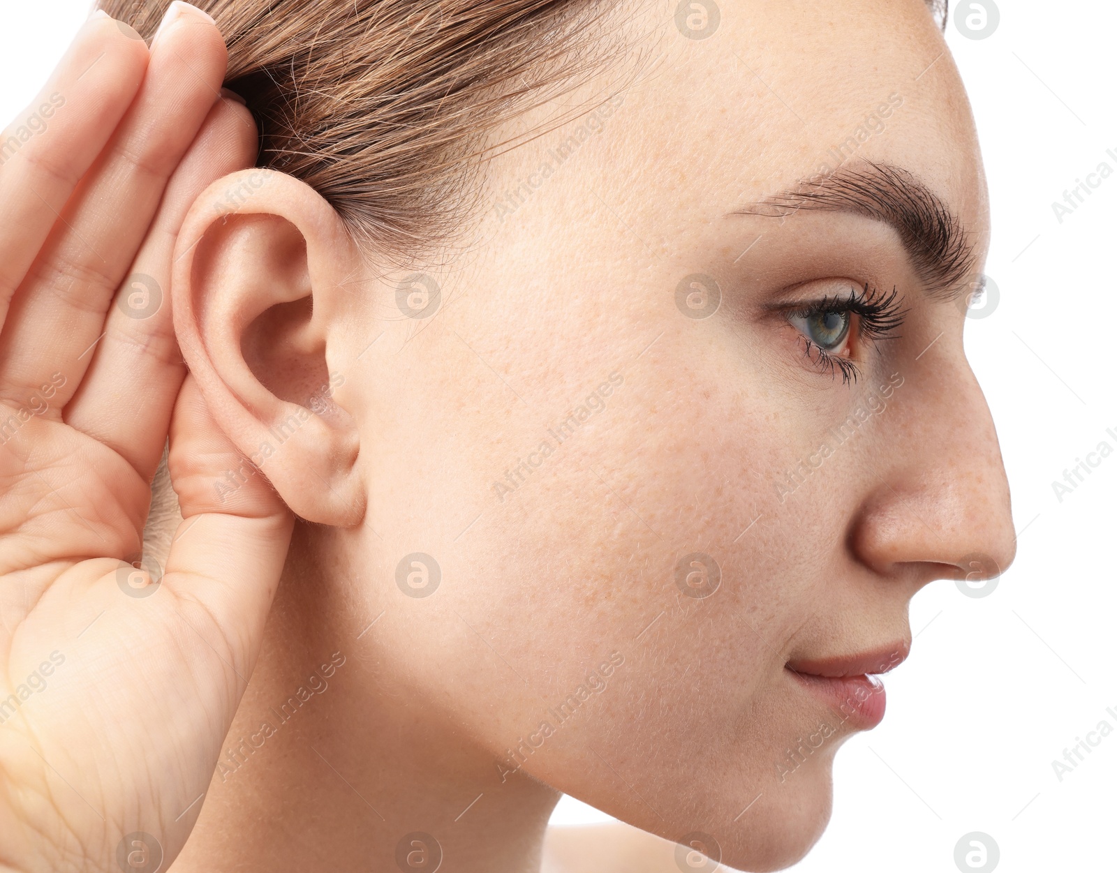 Photo of Sound. Woman showing hand to ear gesture on white background, closeup