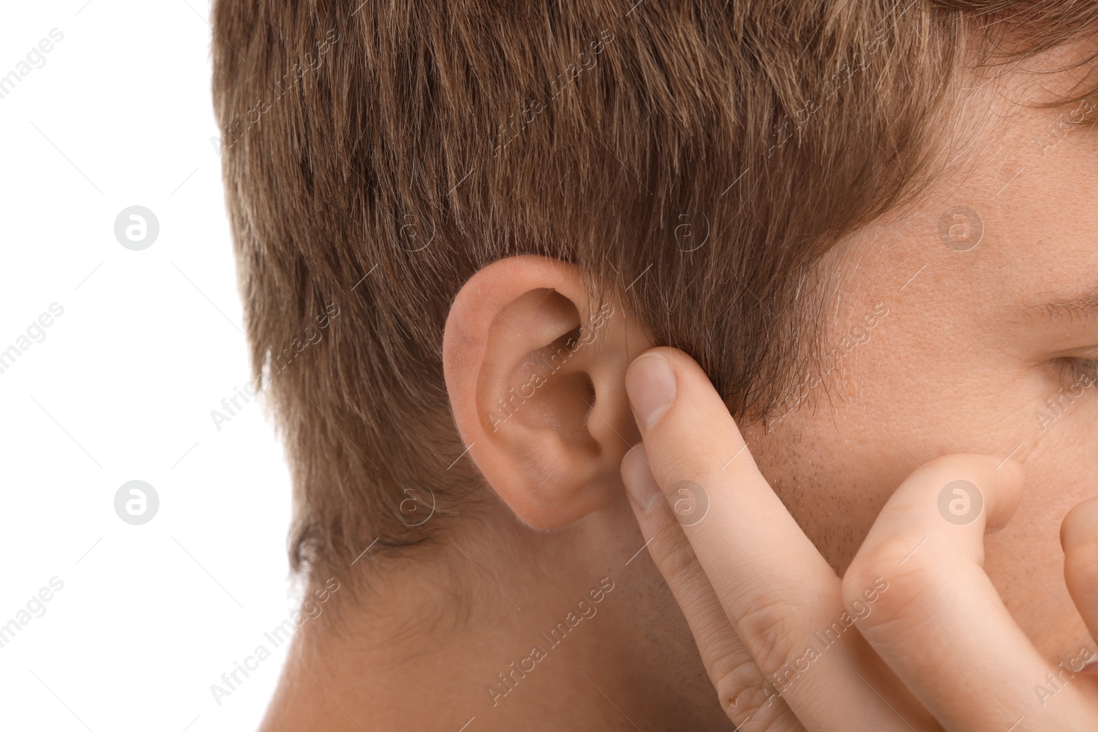 Photo of Sound. Man touching his ear on white background, closeup