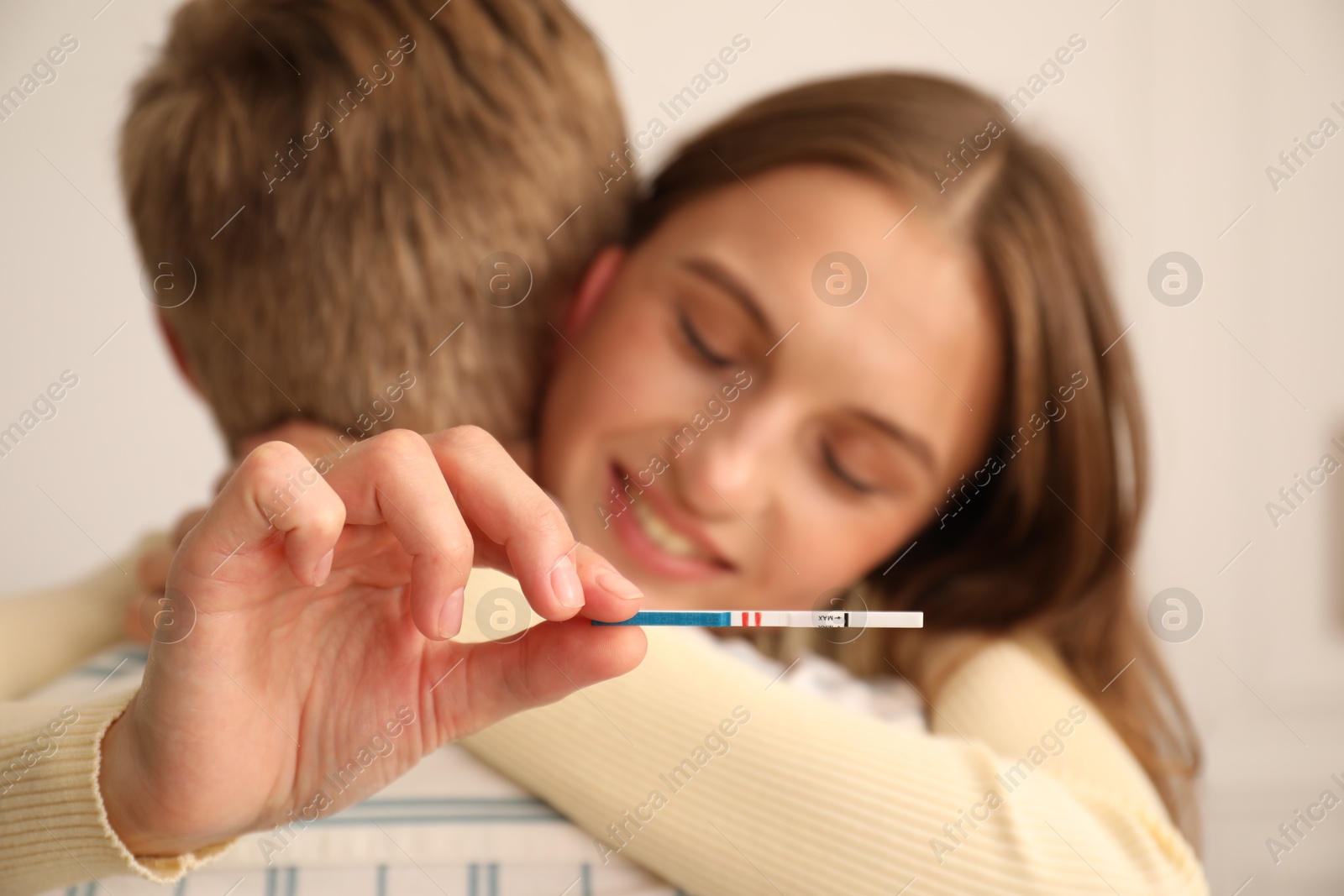 Happy couple with pregnancy test at home, selective focus Photo of Happy couple with pregnancy test at home, selective focus