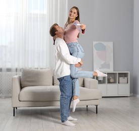 Photo of Happy couple with pregnancy test at home