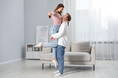 Photo of Happy couple with pregnancy test at home