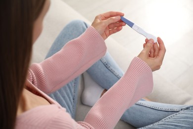 Photo of Woman with negative pregnancy test at home, closeup