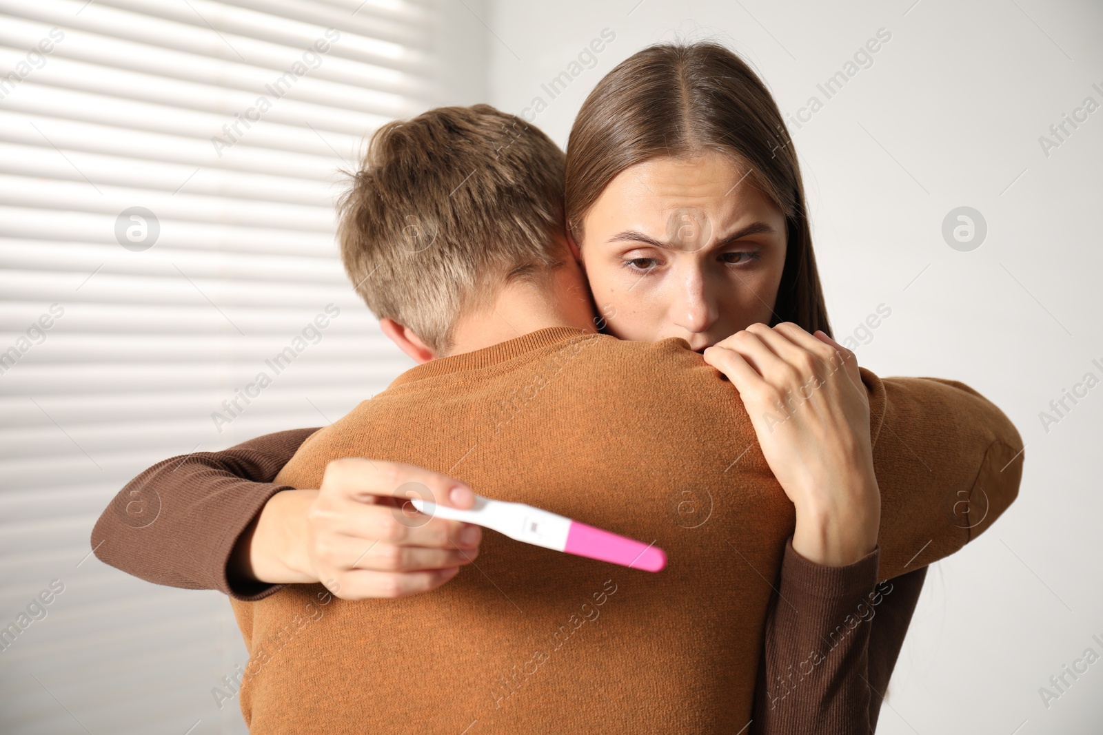 Worried couple with pregnancy test at home Photo of Worried couple with pregnancy test at home