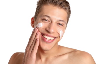 Photo of Handsome young man applying cream onto his face on white background, closeup
