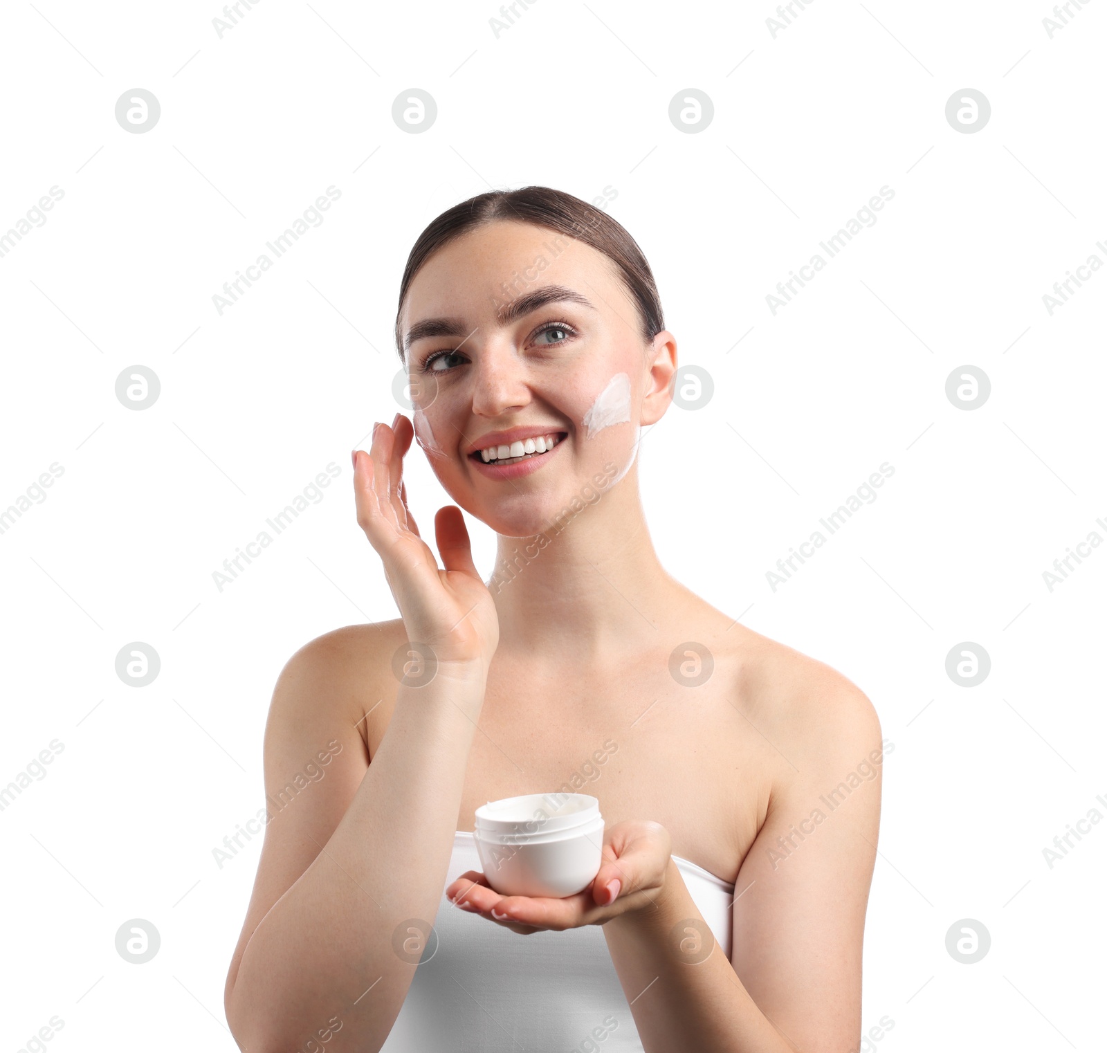 Photo of Beautiful woman applying cream onto her face on white background