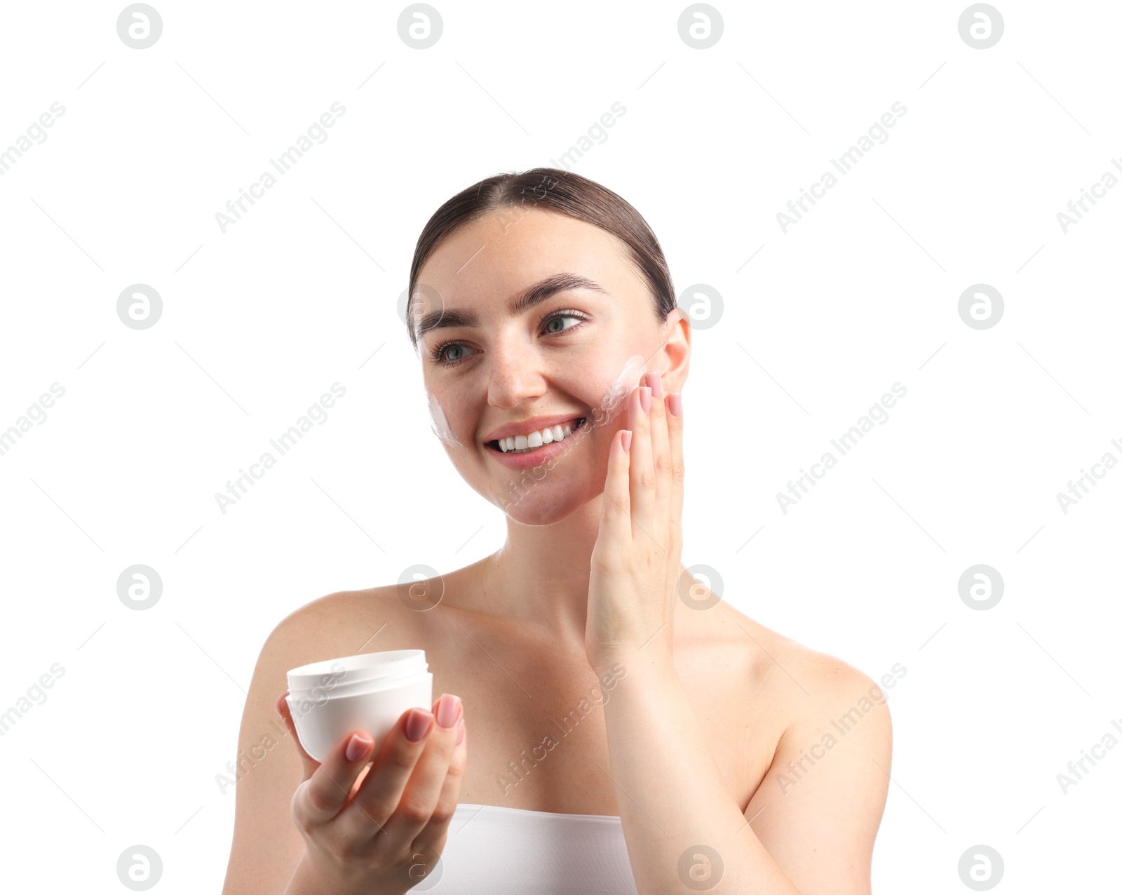Photo of Beautiful woman applying cream onto her face on white background