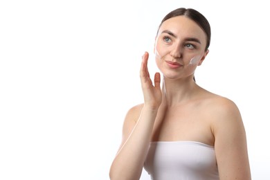Photo of Beautiful woman with cream on her face against white background