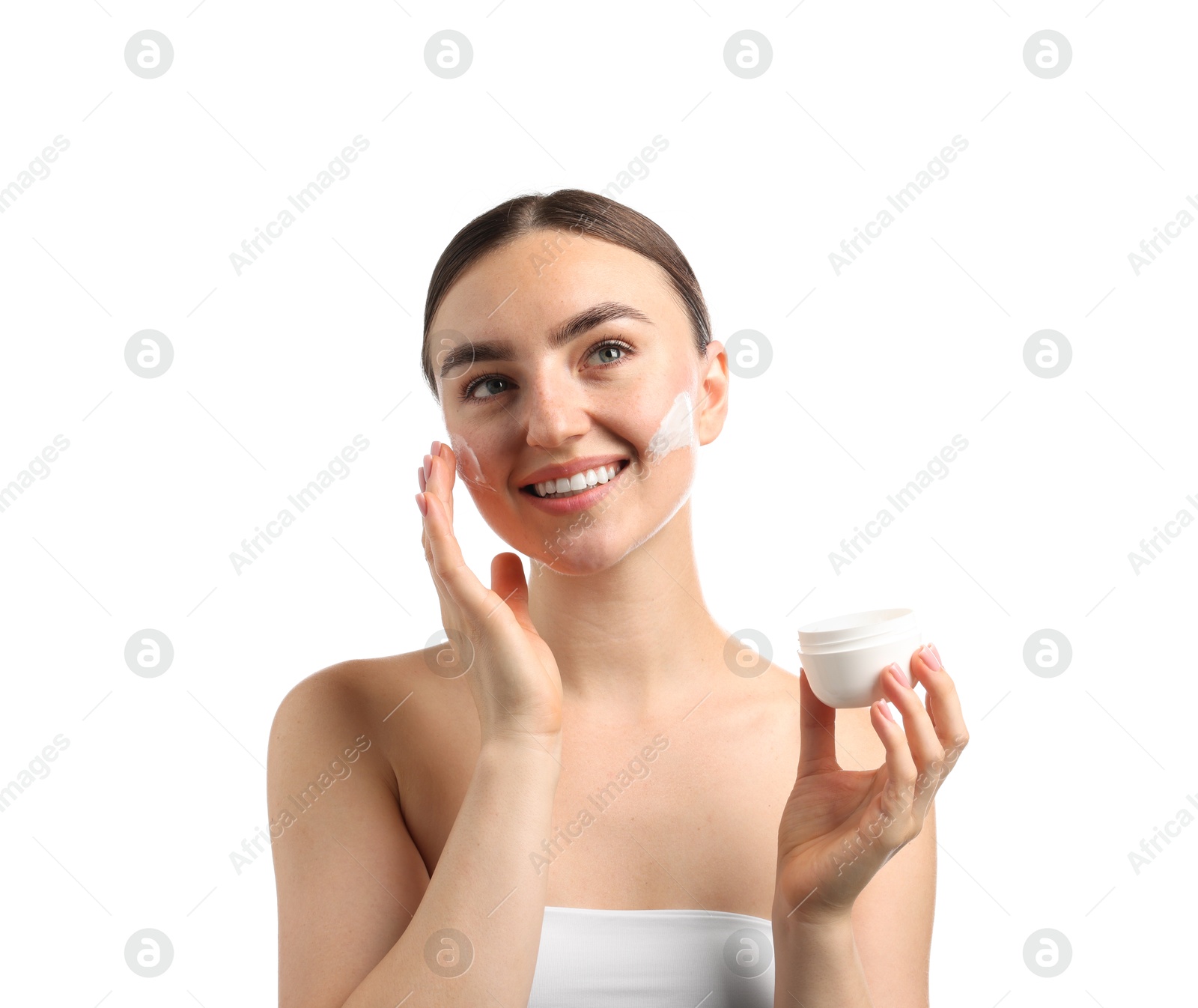 Photo of Beautiful woman applying cream onto her face on white background