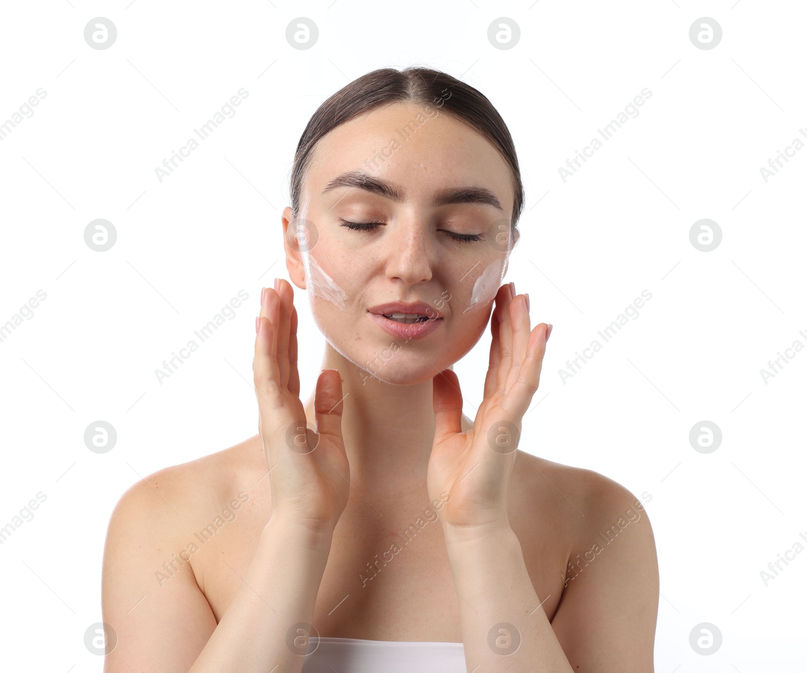 Photo of Beautiful woman with cream on her face against white background