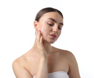 Photo of Beautiful woman with cream on her face against white background