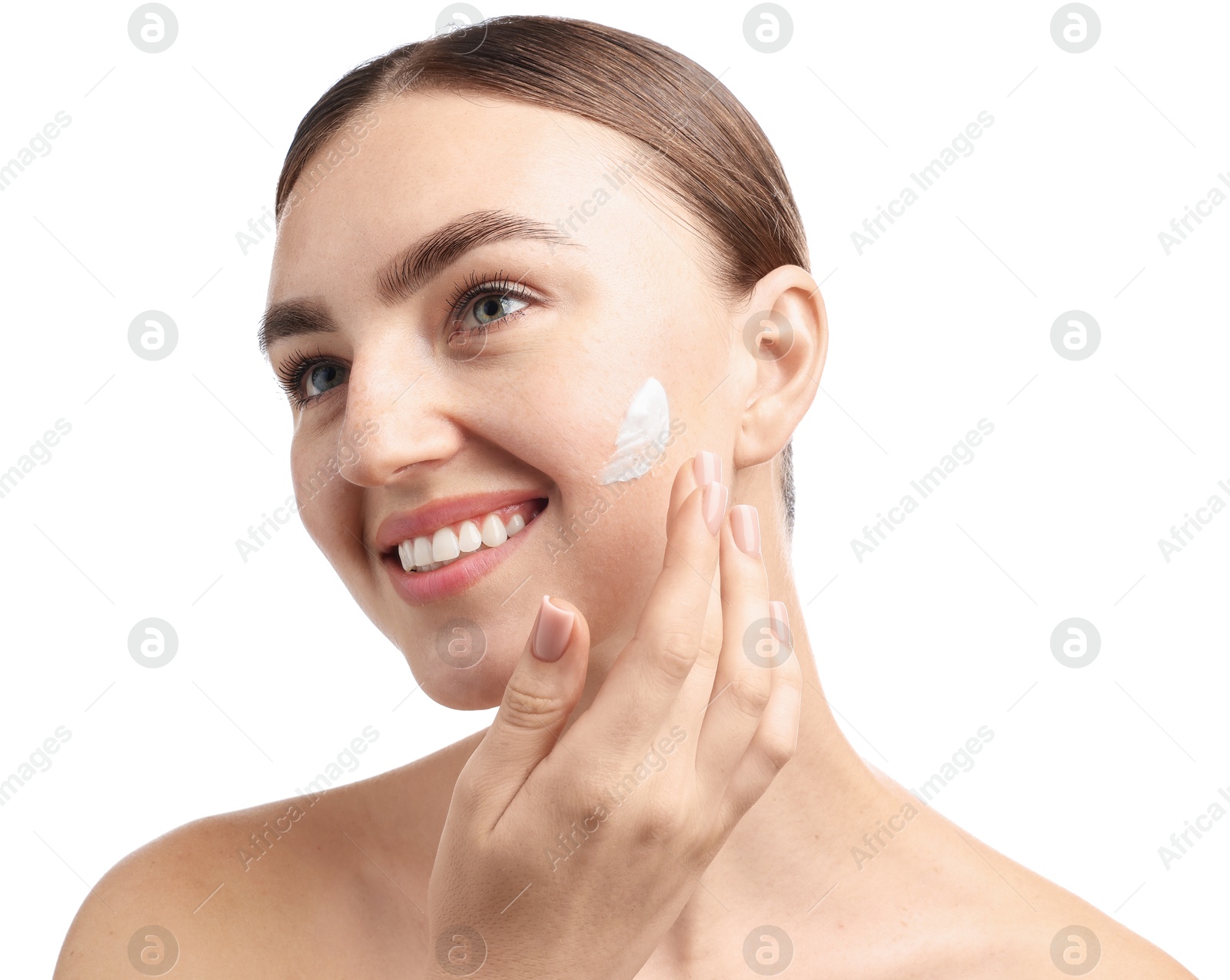 Photo of Beautiful woman applying cream onto her face on white background