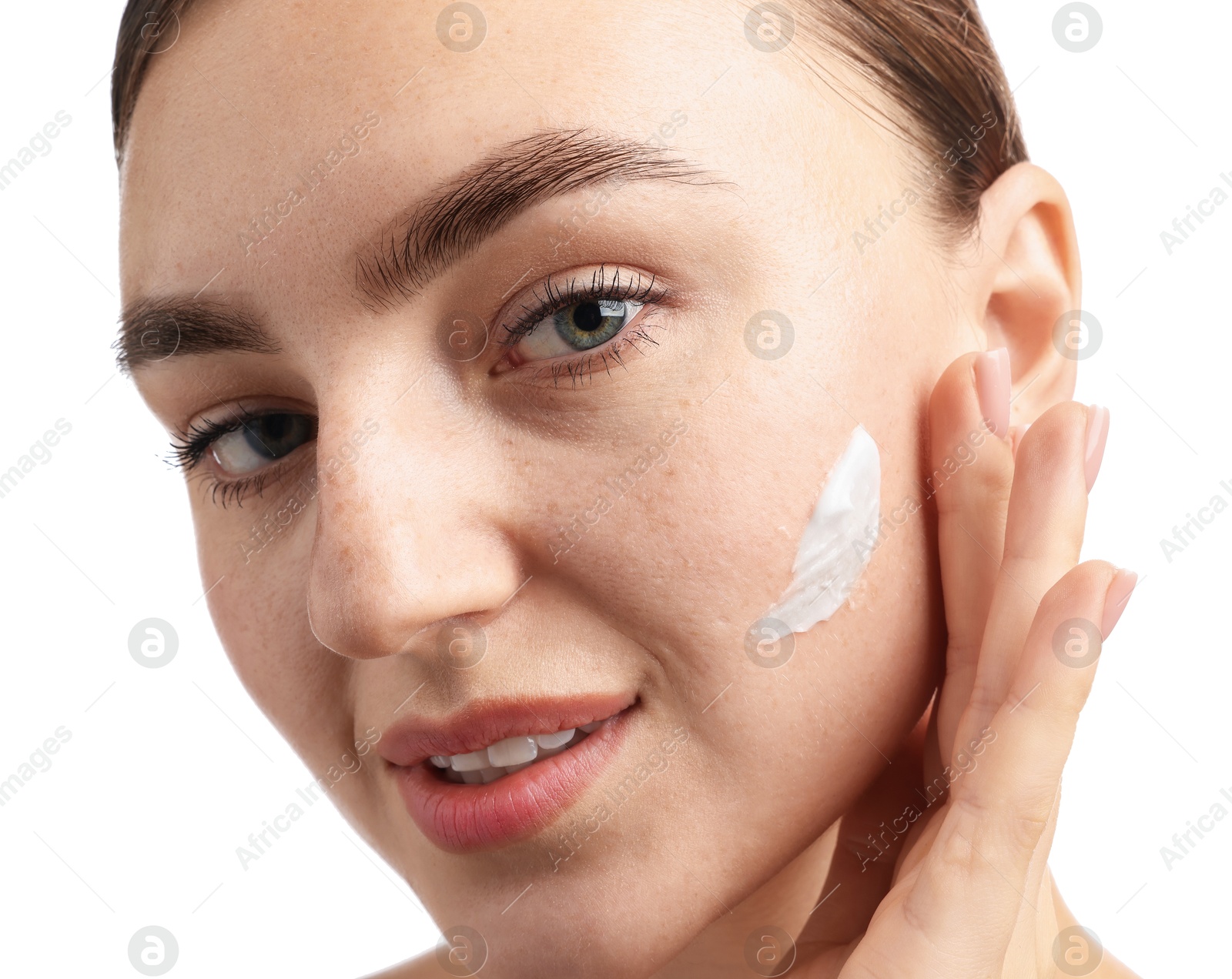 Photo of Beautiful woman with cream on her face against white background, closeup