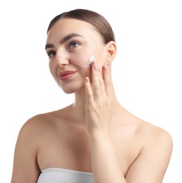 Photo of Beautiful woman applying cream onto her face on white background
