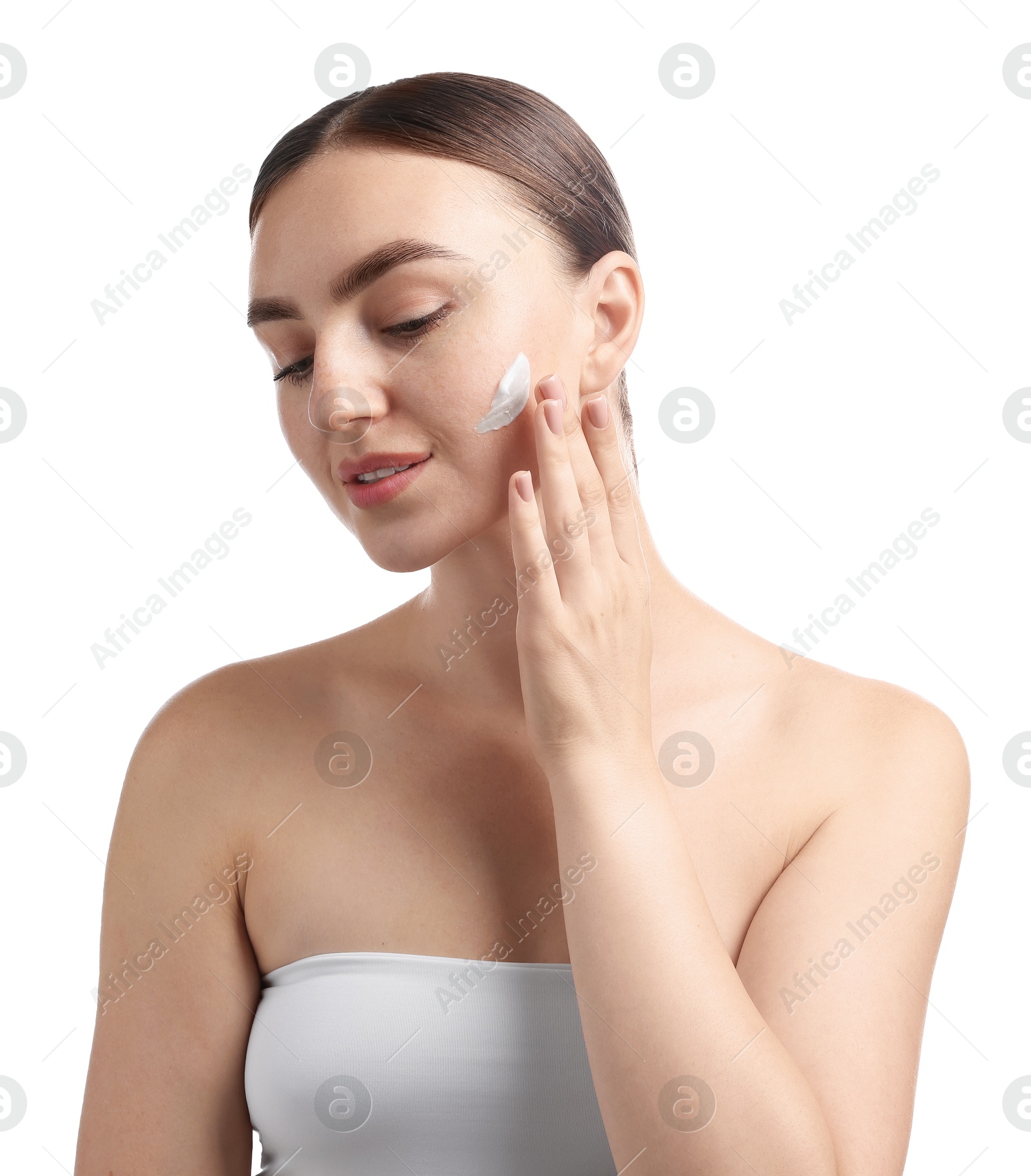 Photo of Beautiful woman with cream on her face against white background