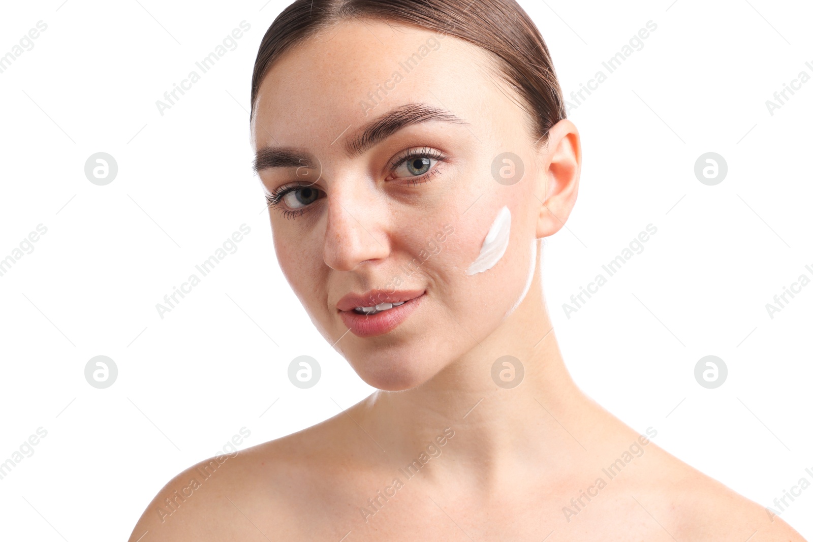 Photo of Beautiful woman with cream on her face against white background, closeup