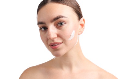 Photo of Beautiful woman with cream on her face against white background, closeup