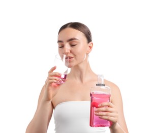 Photo of Woman rinsing mouth with mouthwash on white background. Oral hygiene