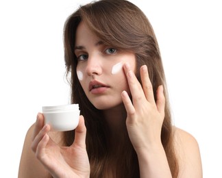 Photo of Beautiful woman applying cream onto her face on white background