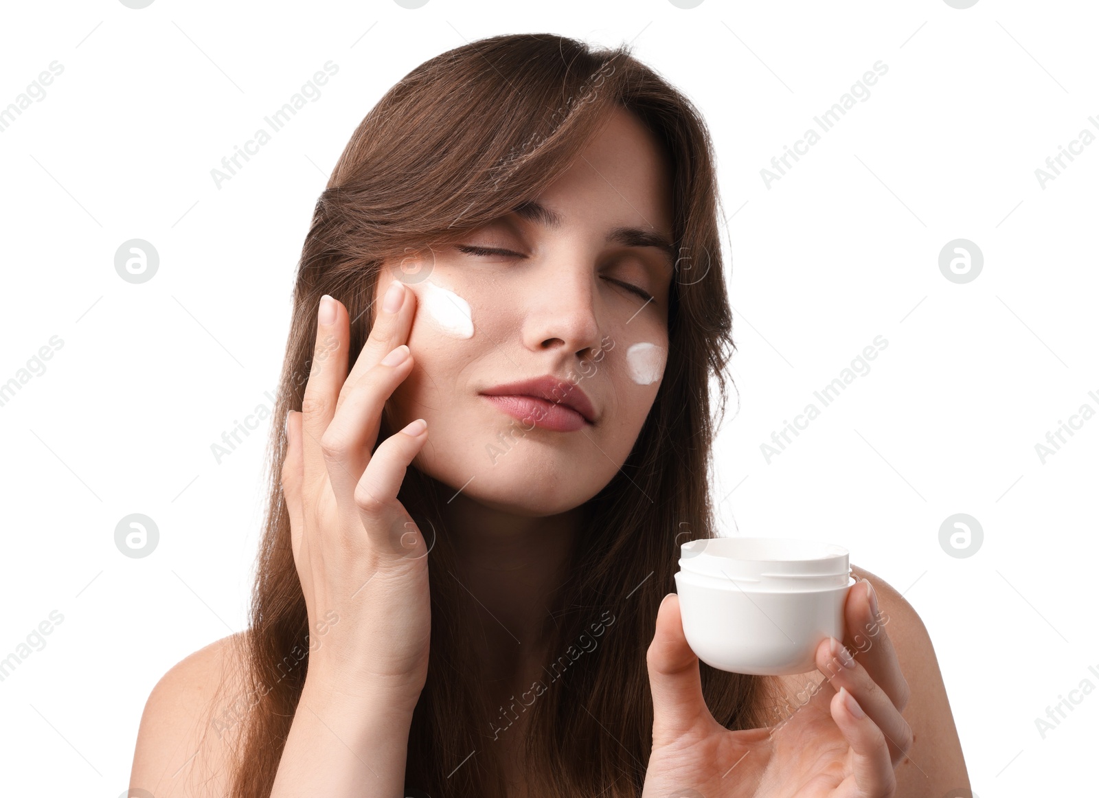Photo of Beautiful woman applying cream onto her face on white background
