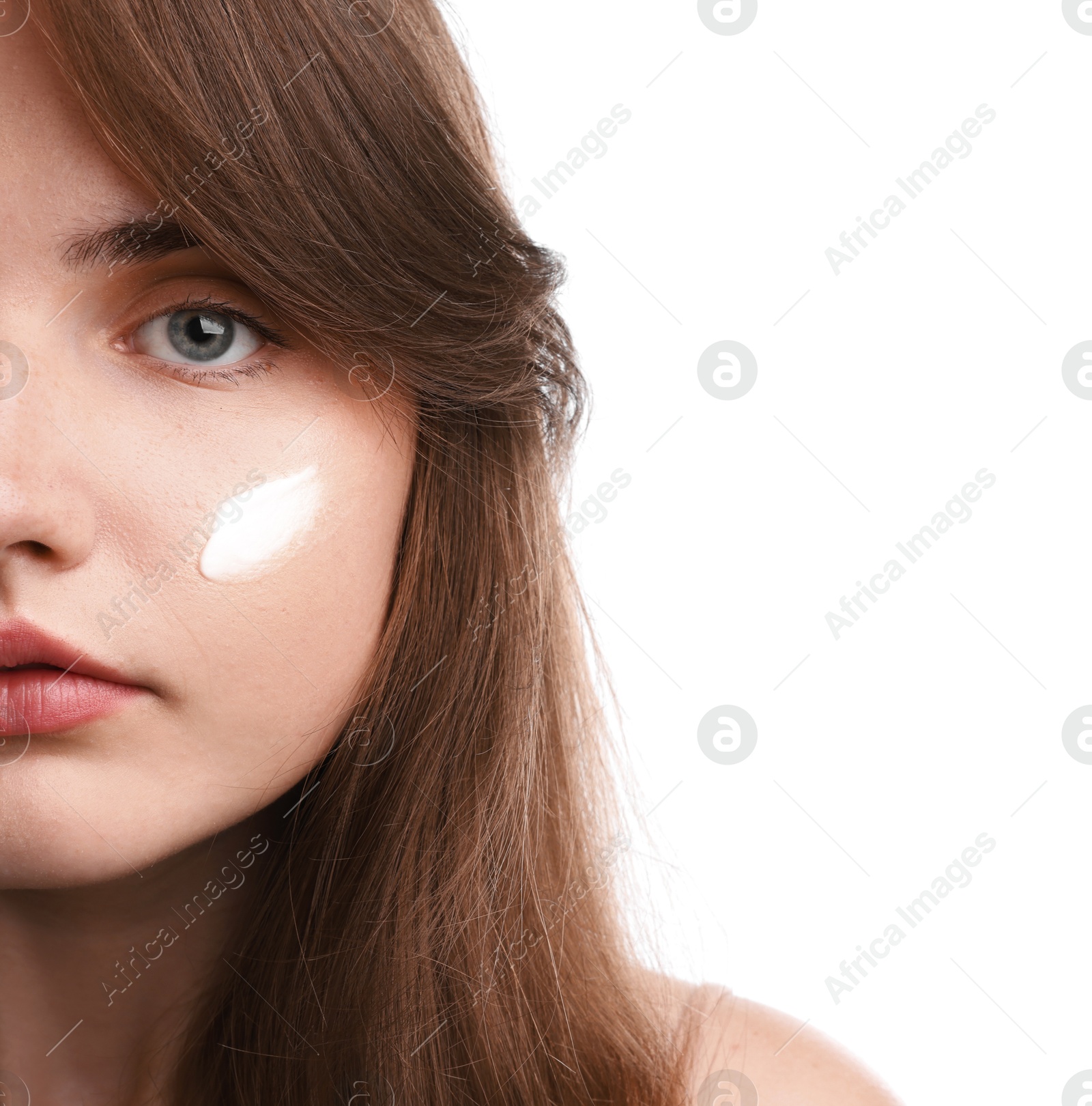 Photo of Beautiful woman with cream on her face against white background, closeup