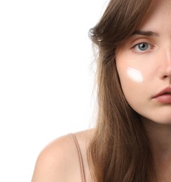 Photo of Beautiful woman with cream on her face against white background, closeup