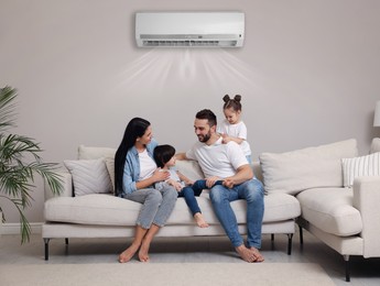 Image of Happy family on sofa in living room. Air conditioner keeping comfortable temperature in room