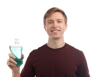 Photo of Man with bottle of mouthwash on white background. Oral hygiene