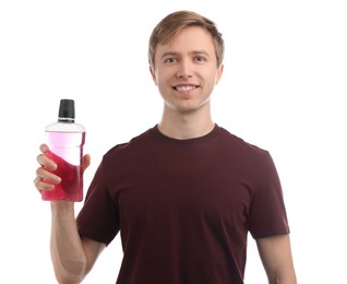 Photo of Man with bottle of mouthwash on white background. Oral hygiene