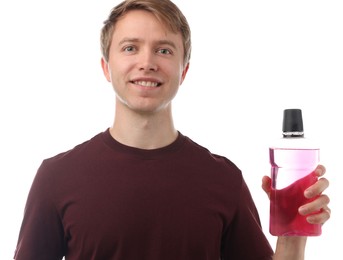 Photo of Man with bottle of mouthwash on white background. Oral hygiene