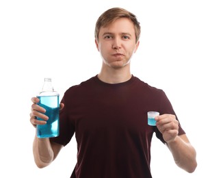 Photo of Man with mouthwash on white background. Oral hygiene