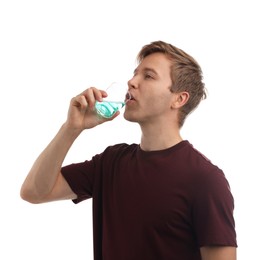 Photo of Man rinsing mouth with mouthwash on white background. Oral hygiene