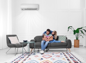 Image of Happy family having fun together at home. Air conditioner keeping comfortable temperature in room