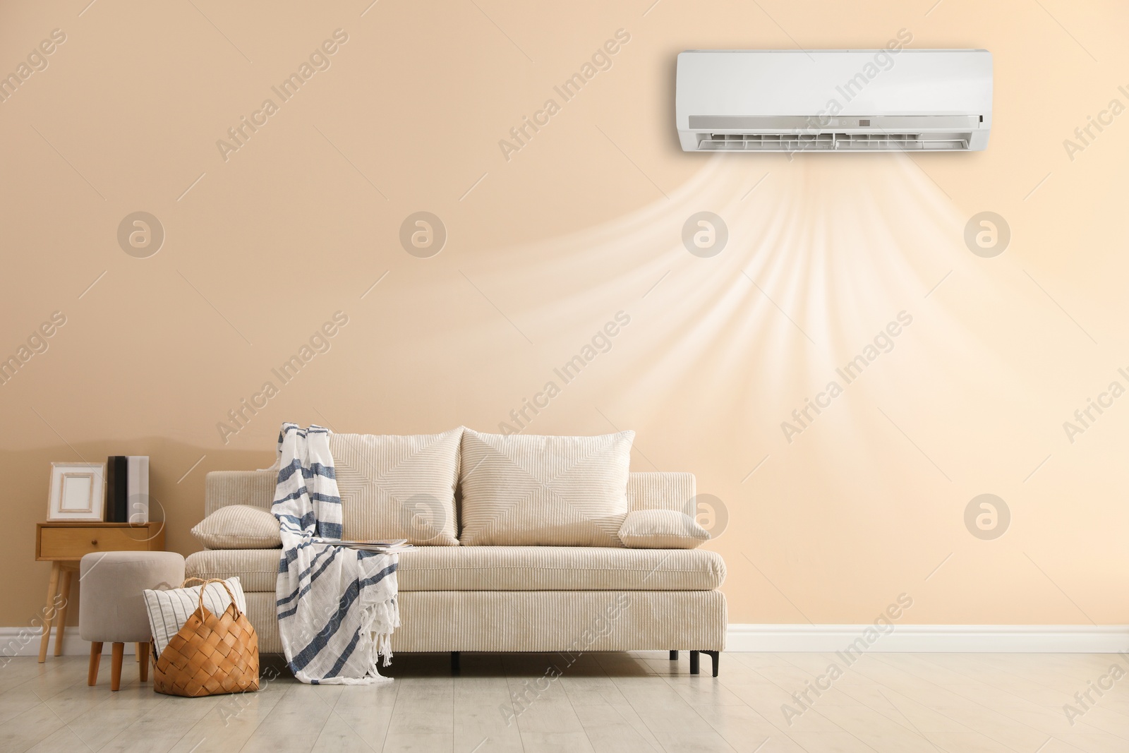 Image of Air conditioner on wall above sofa in living room