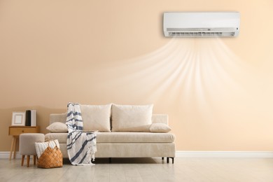 Image of Air conditioner on wall above sofa in living room