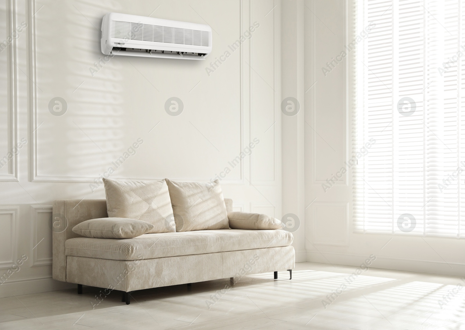 Image of Air conditioner on wall above sofa in living room