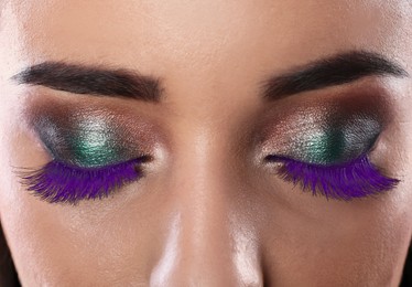 Image of Young woman with beautiful makeup and purple eyelashes, closeup