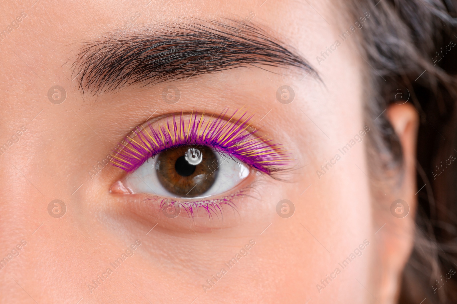 Image of Young woman with beautiful colorful eyelashes, closeup