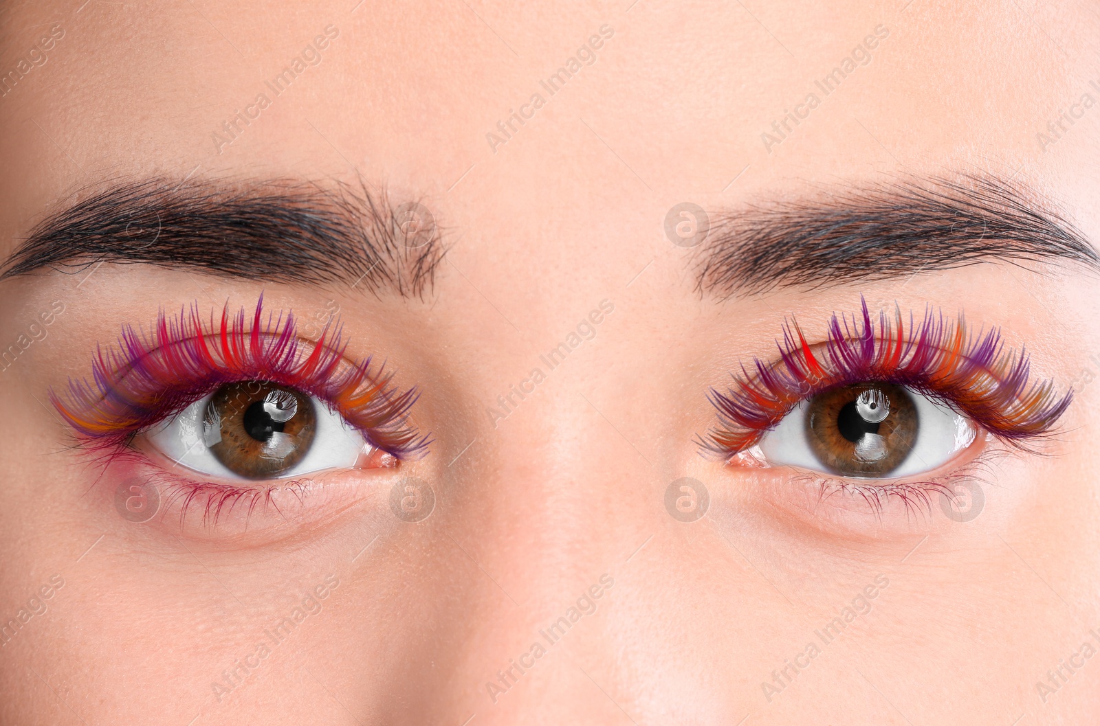Image of Young woman with beautiful colorful eyelashes, closeup