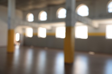 Photo of Blurred view of spacious room with many windows