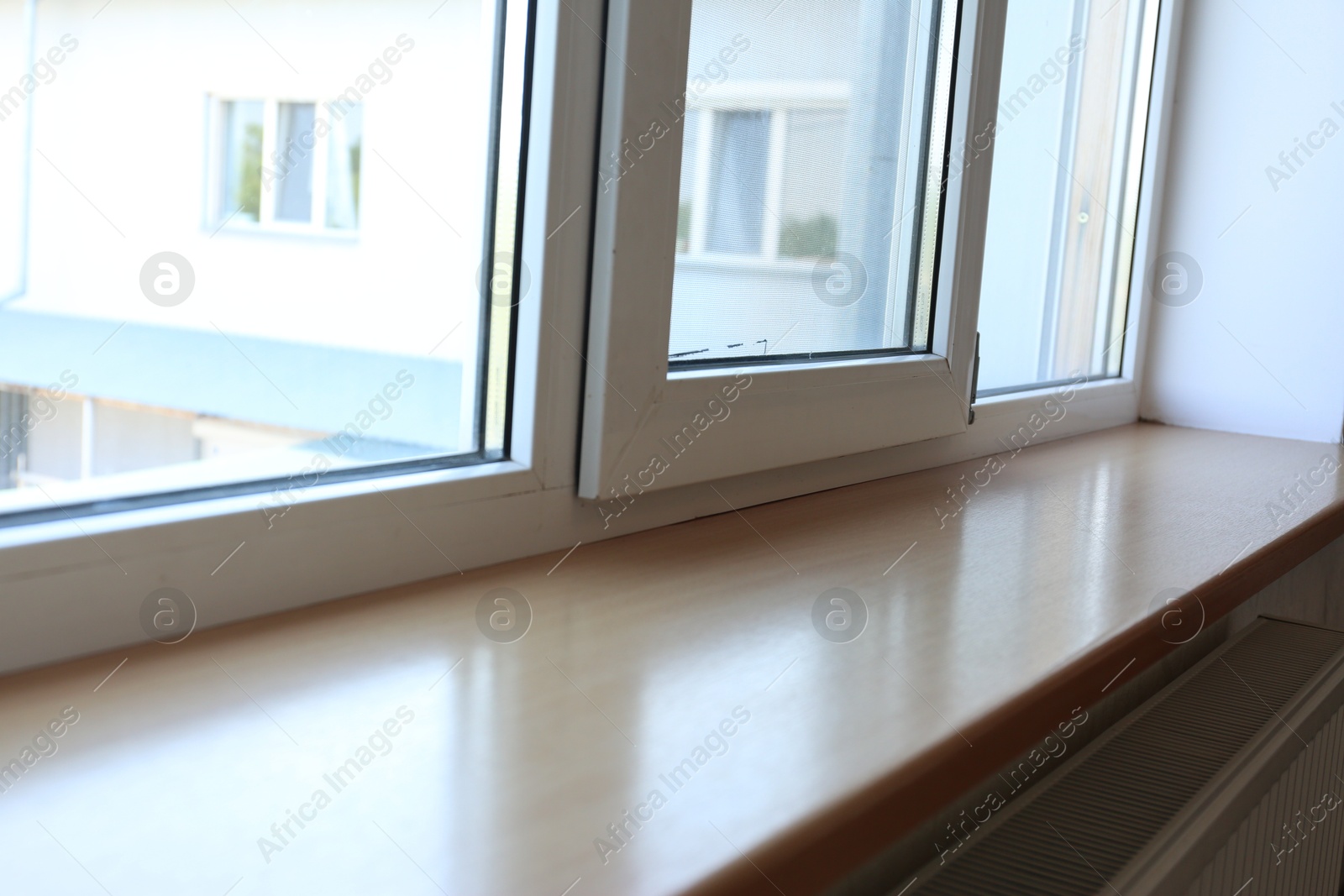 Photo of Closeup of plastic window with wooden sill
