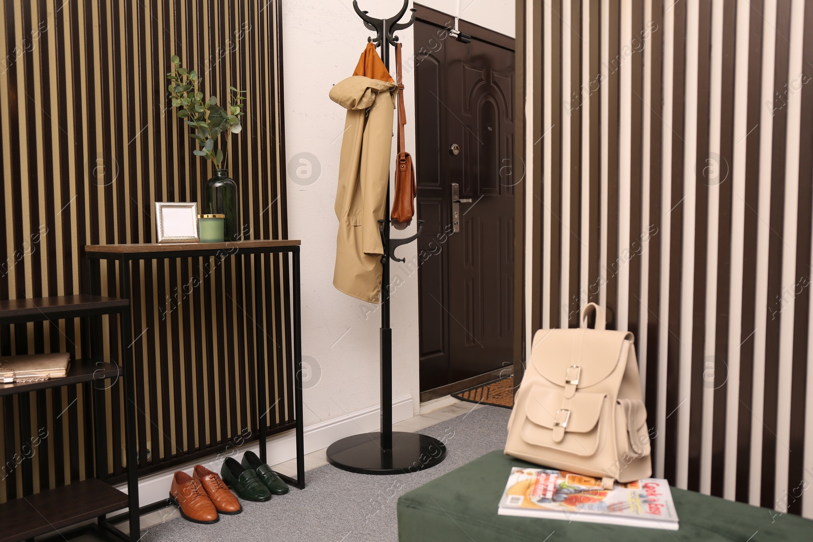 Photo of Modern hallway interior with console table and clothes rack